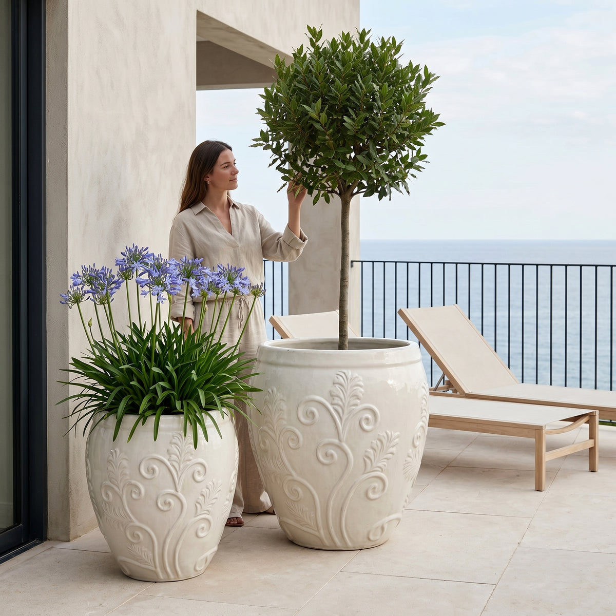 52x58 cm Cream Gaia glazed ceramic planter, with shrub on a landscaped terrace