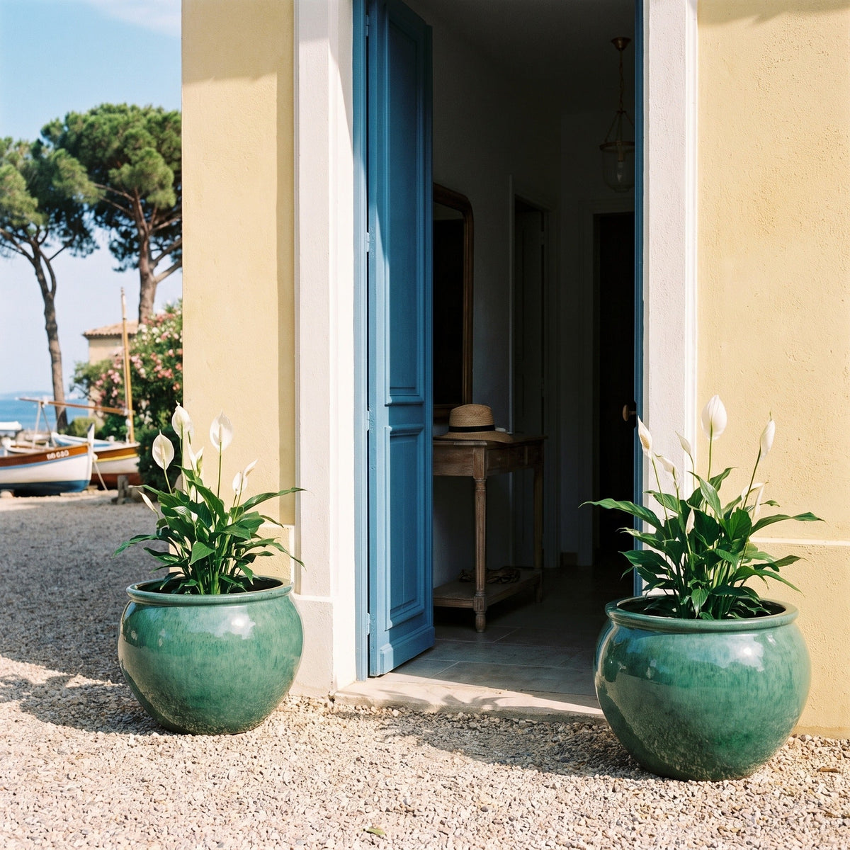 Round LUTECE planter 53x43 cm jade glazed ceramic, in pairs in front of an entrance