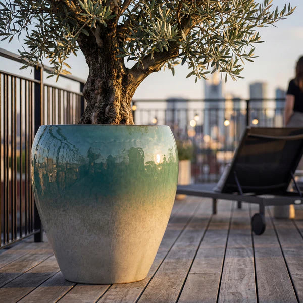 Summer mist Lafontaine2 amphora-shaped glazed ceramic planter, close-up with an olive tree on a terrace
