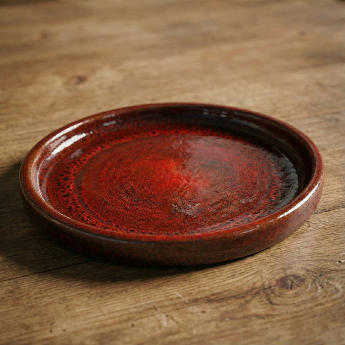 Tropical Red saucer, angled view on a wooden table