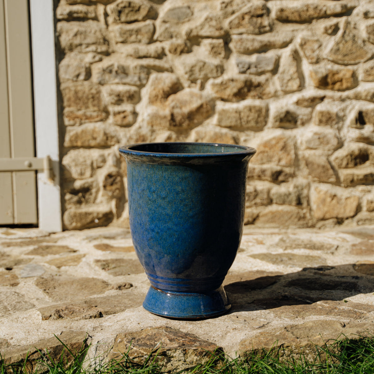 Arthur planter with base 32x39 cm Ultramarine Blue glazed ceramic, front view on outdoor paving