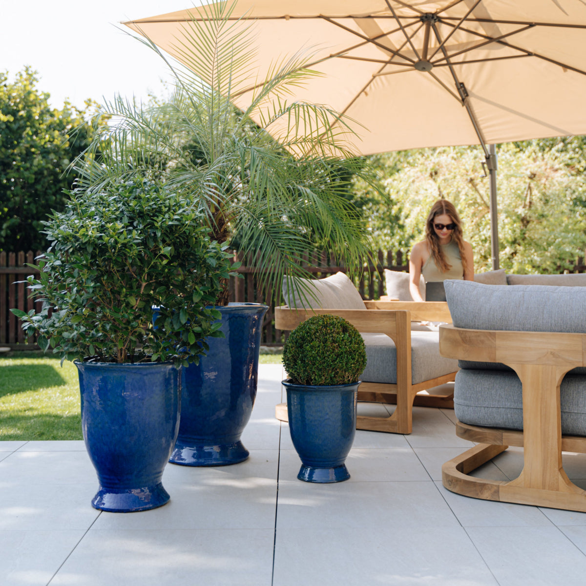 Arthur planter with base Ultramarine Blue glazed ceramic, with shrubs on a terrace