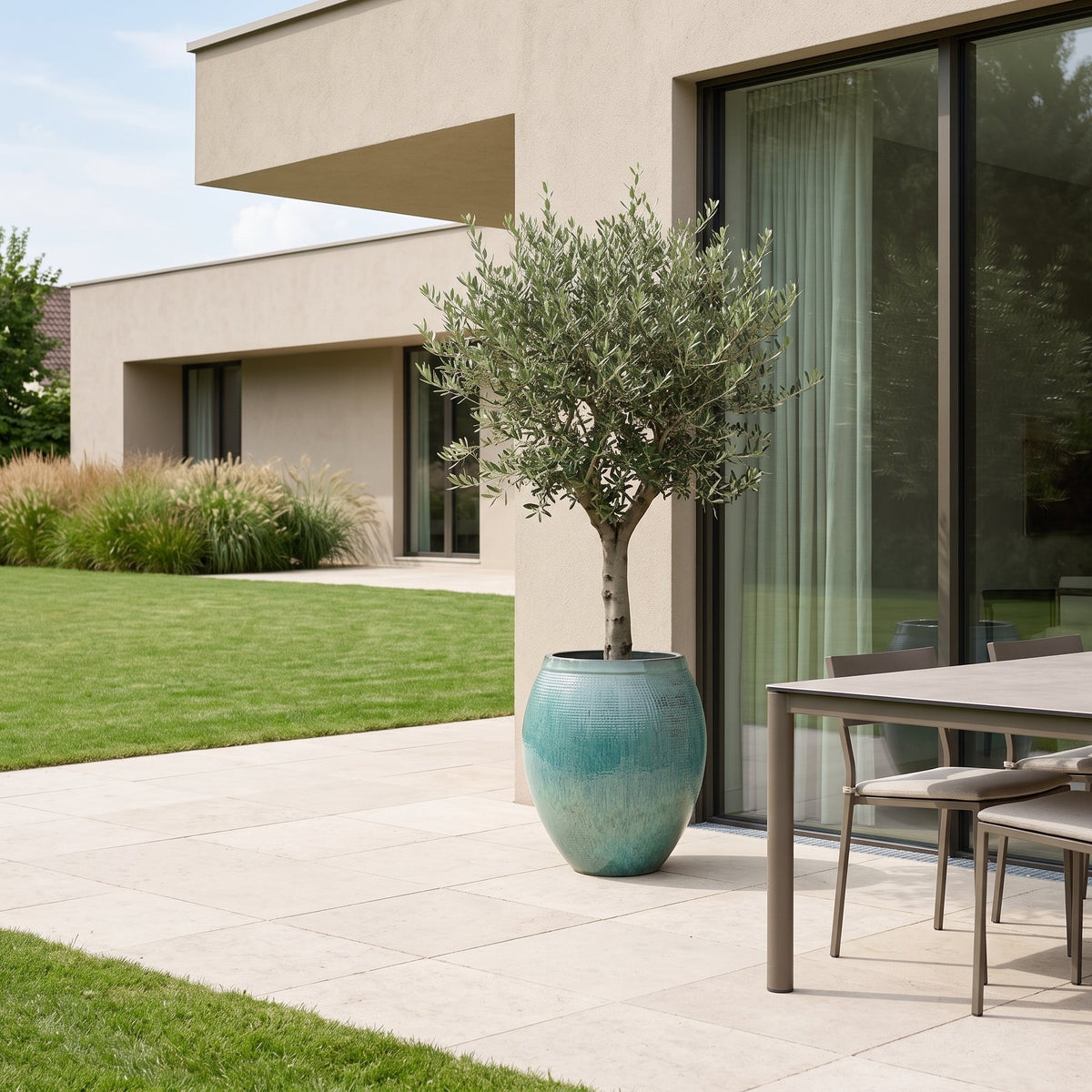 Cocoon 42x53 cm Ocean Blue glazed ceramic planter, with olive tree on a terrace