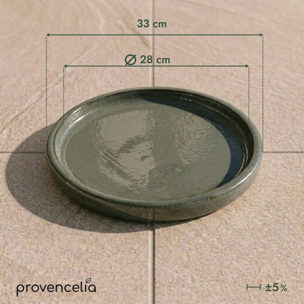 Platillo de 28 cm Verde crema, vista superior sobre baldosas