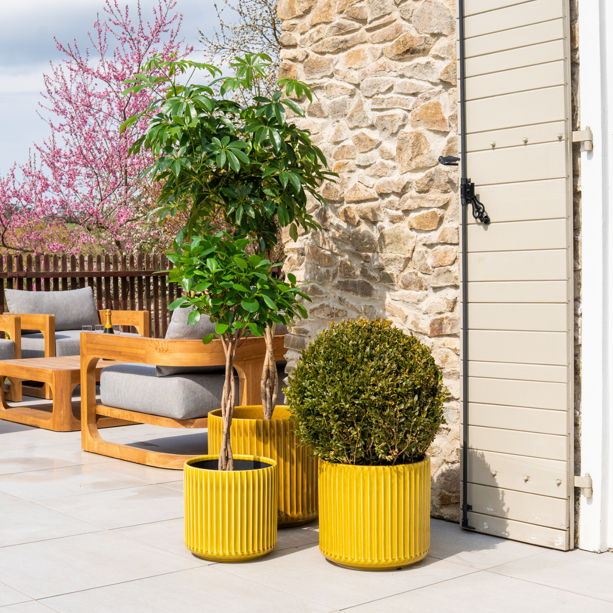 Pot London décoratif 35x33 cm heliodore, parmi trois pots sur terrasse