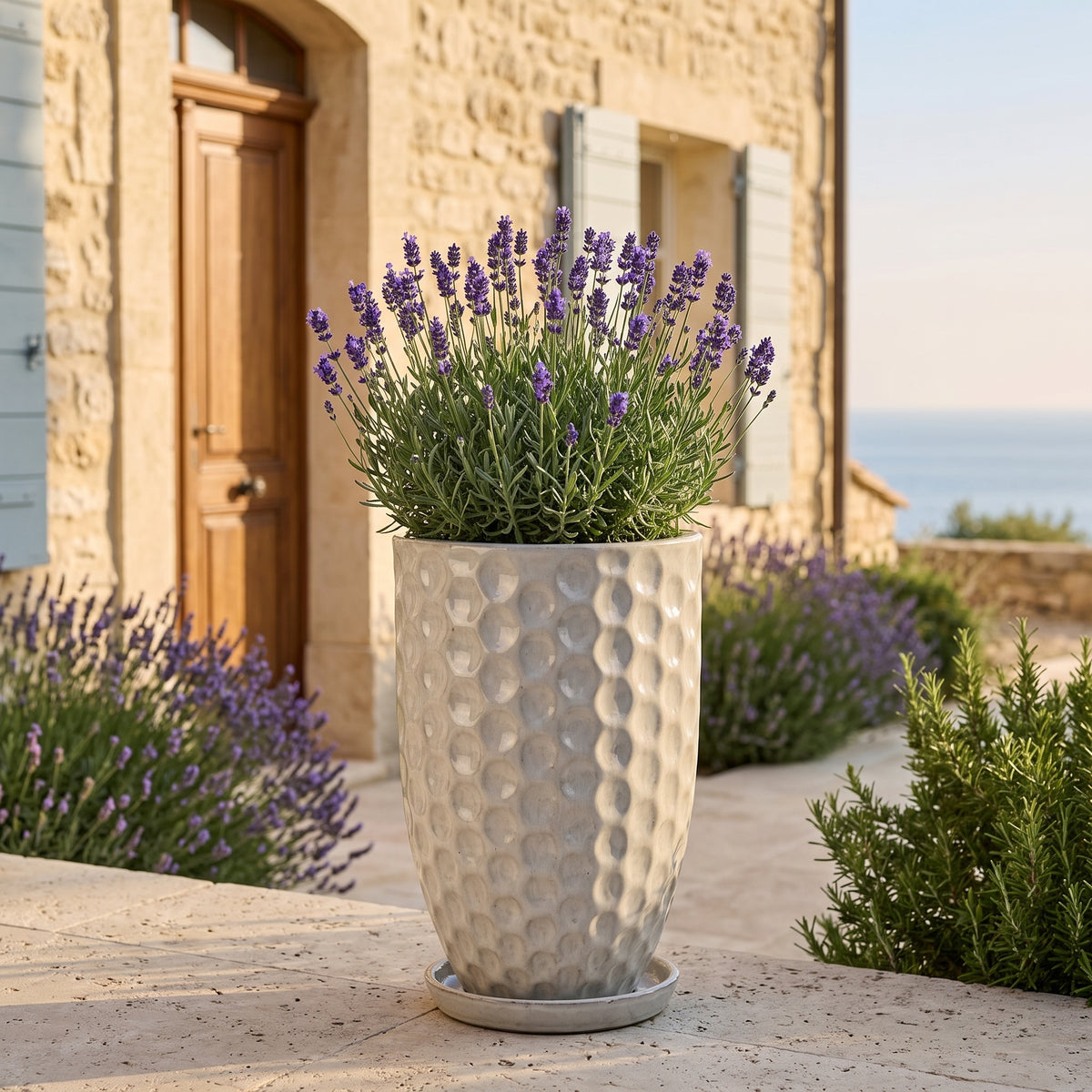 Merovee planter 30x45 cm Cream glazed ceramic, lavender in front of a stone house