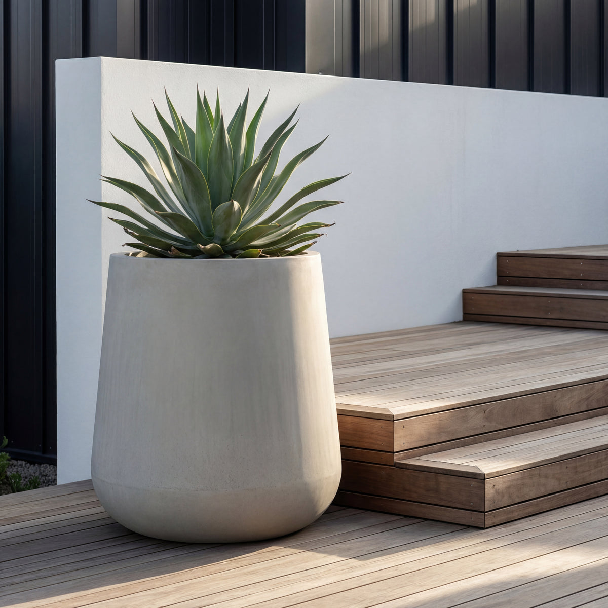 Pre-drilled Silex cachepot beige in fibre concrete, with agave on a wooden terrace