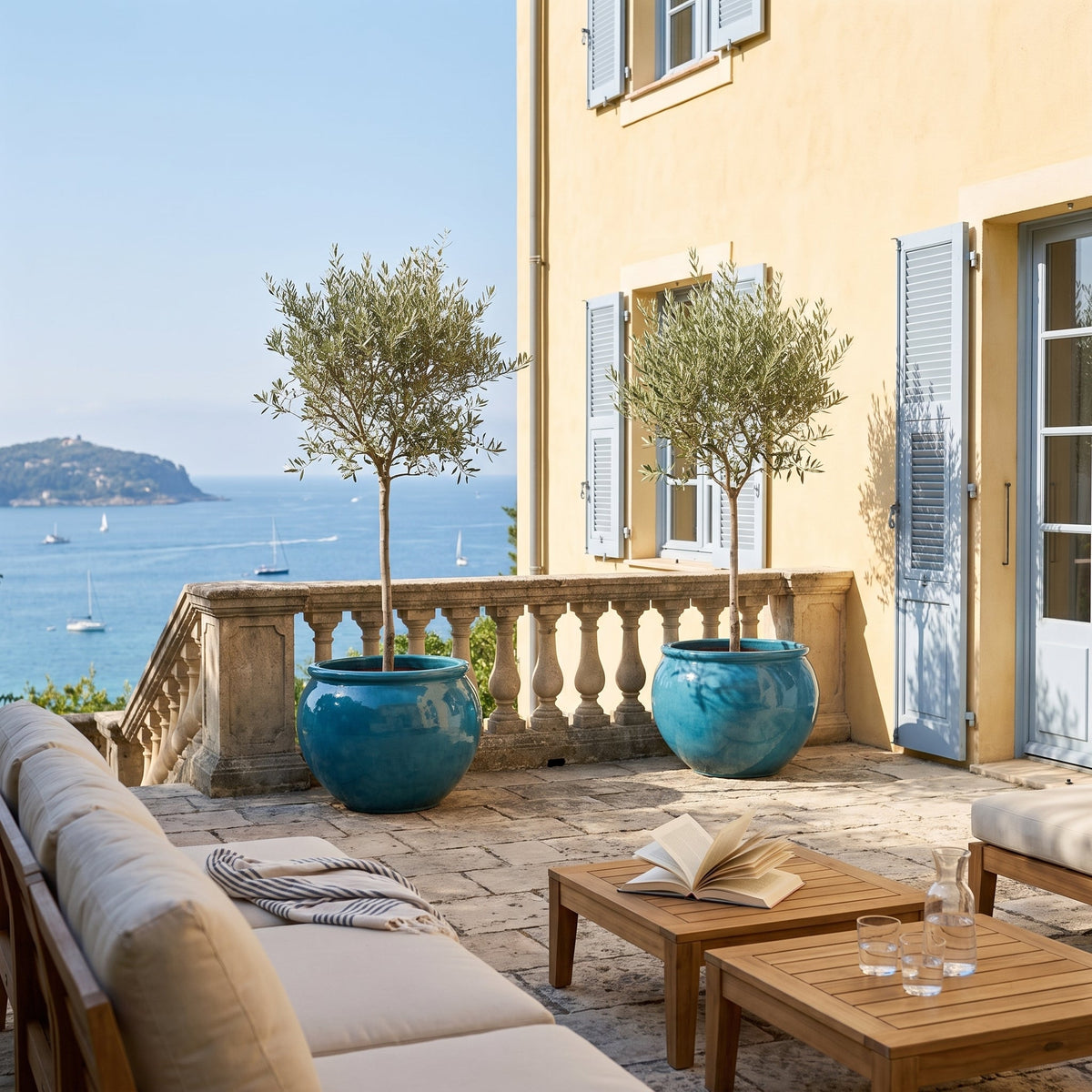 Round LUTECE planter 86x64 cm in Caribbean Blue glazed ceramic, with an olive tree on a sea-facing terrace